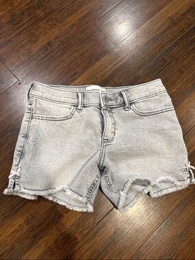abercrombie kids light gray frayed denim shorts with light pink side bows.